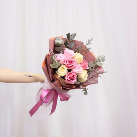 Someone holding a Vin Florist's Magenta Pink bouquet